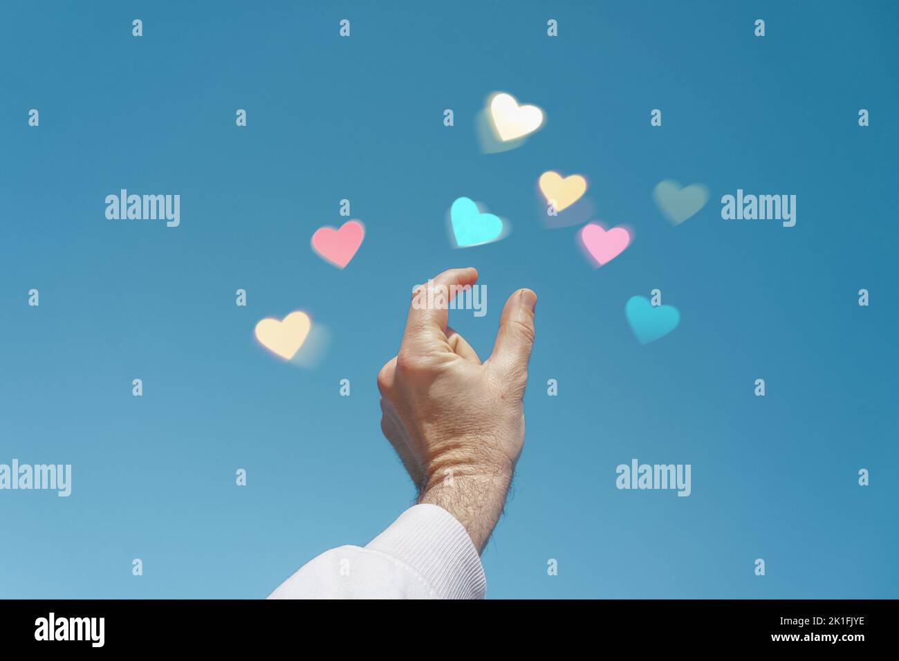 la main vers le haut dans le ciel touchant une forme de coeur, l'amour des émotions dans le jour de la saint valentin Banque D'Images