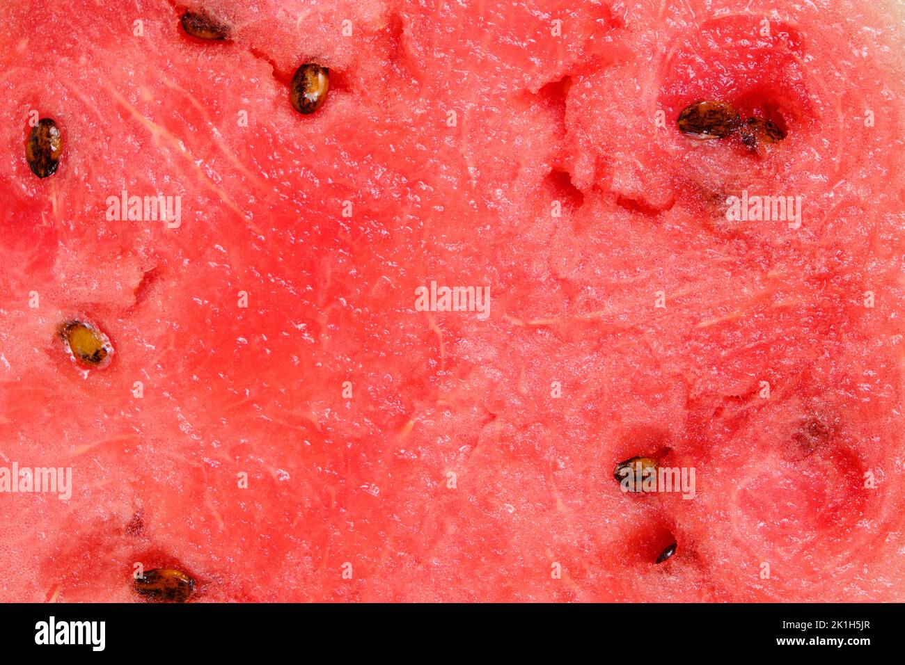 Fond pulpe de pastèque rouge avec graines noires Banque D'Images