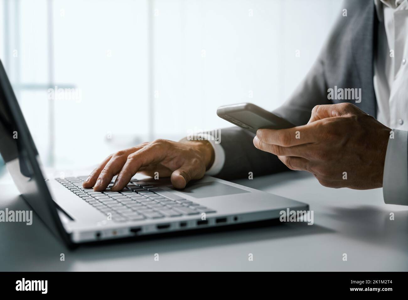 homme d'affaires utilisant un smartphone et travaillant sur un ordinateur portable au bureau. gestion d'entreprise et concept de solutions numériques Banque D'Images