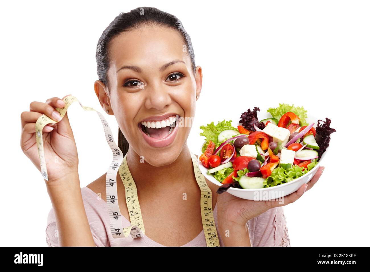 Voir les résultats. Portrait d'une jeune femme attrayante tenant un mètre ruban et un bol de salade. Banque D'Images