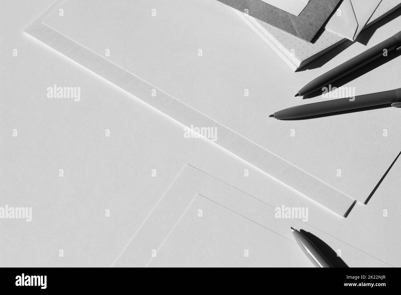 Maquette de bureau de conception minimale. Papiers vierges, enveloppes et papier à lettres sur fond blanc avec espace de copie. Banque D'Images