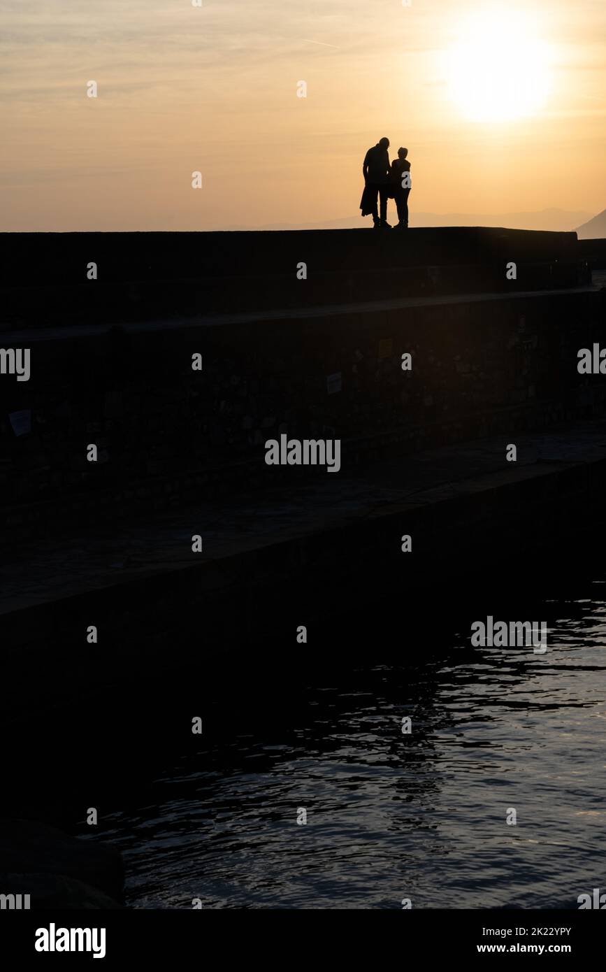 Les personnes qui apprécient le coucher du soleil à Camogli, un village de pêcheurs et une station touristique près de la péninsule de Portofino, sur le Golfo Paradiso dans la Riviera di L. Banque D'Images