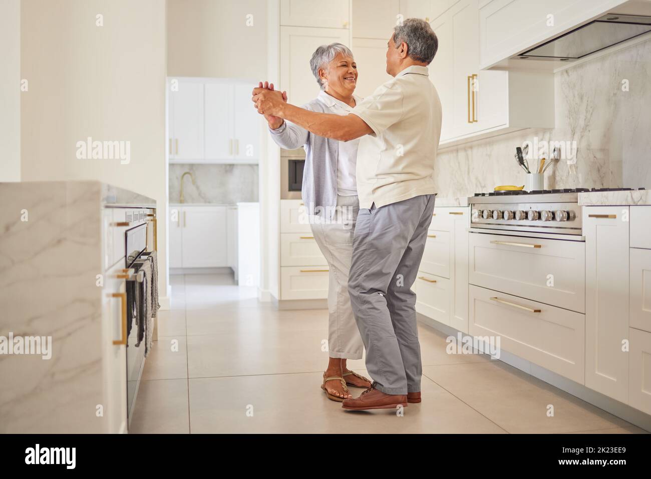 Couple senior danse, cuisine et les personnes âgées amour de passer du temps de qualité ensemble à la maison. Bonne retraite d'une femme et d'un homme du Mexique Banque D'Images