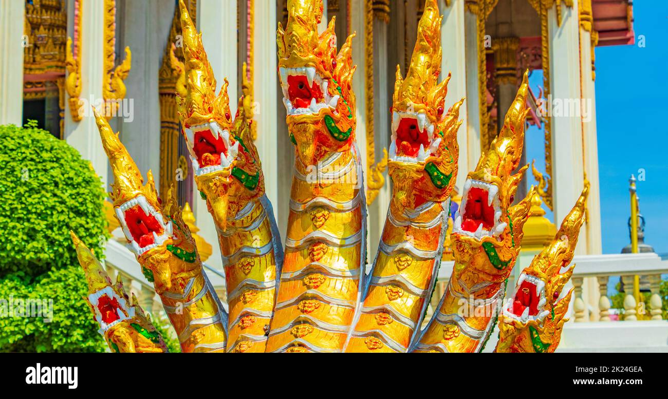 Dragons dorés et verts statues de libellules dans le temple bouddhiste Wat Don Mueang Phra Arramluang coloré à Bangkok en Thaïlande. Banque D'Images