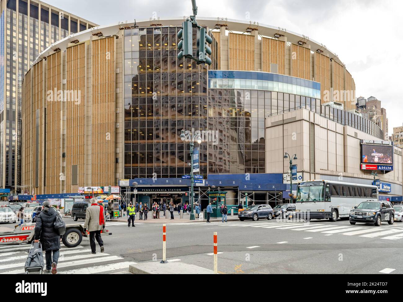 Madison Square Garden avec carrefour en face, circulation dans la rue et les gens qui marchent autour, New York City pendant la journée d'hiver nuageux, horizonta Banque D'Images