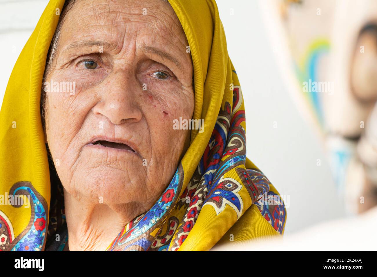 Khomam, IRAN - 16 novembre, 2017 76 ans, femme musulmane âgée avec un portrait de foulard jaune. Province de Gilan Banque D'Images