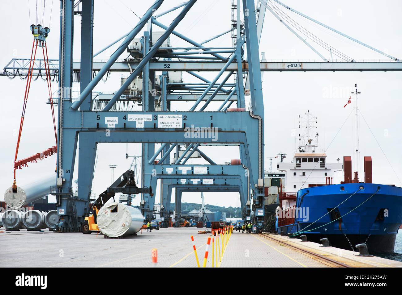 Une journée chargée dans le port.Un énorme cargo amarré au port tout en étant chargé avec des conteneurs. Banque D'Images