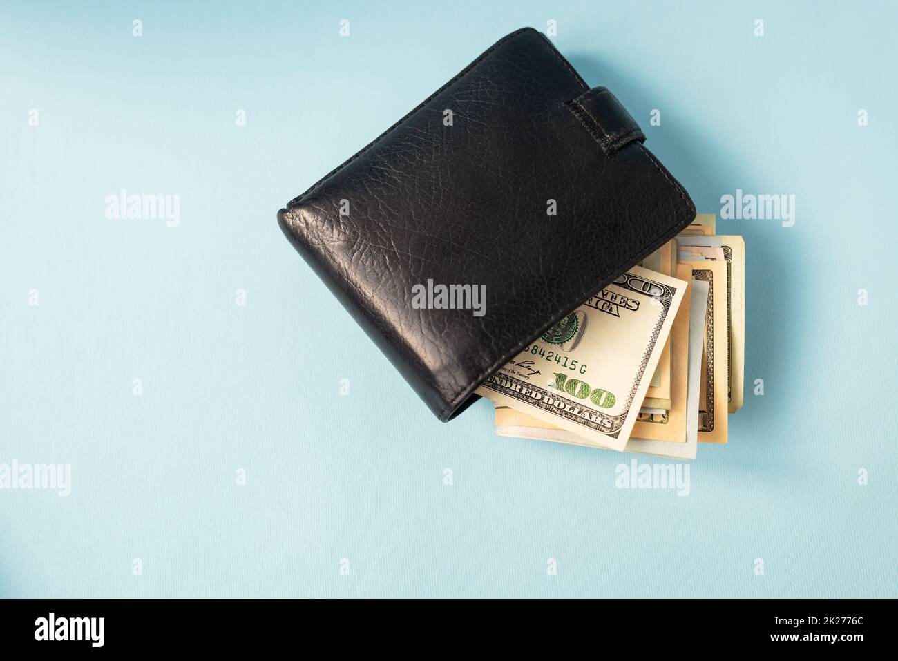 Argent international des billets de 100 dollars se trouvent dans un portefeuille en cuir. Place pour une inscription. Banque D'Images