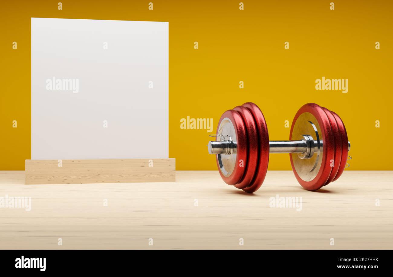 Haltères en acier rouge sur fond jaune Banque D'Images