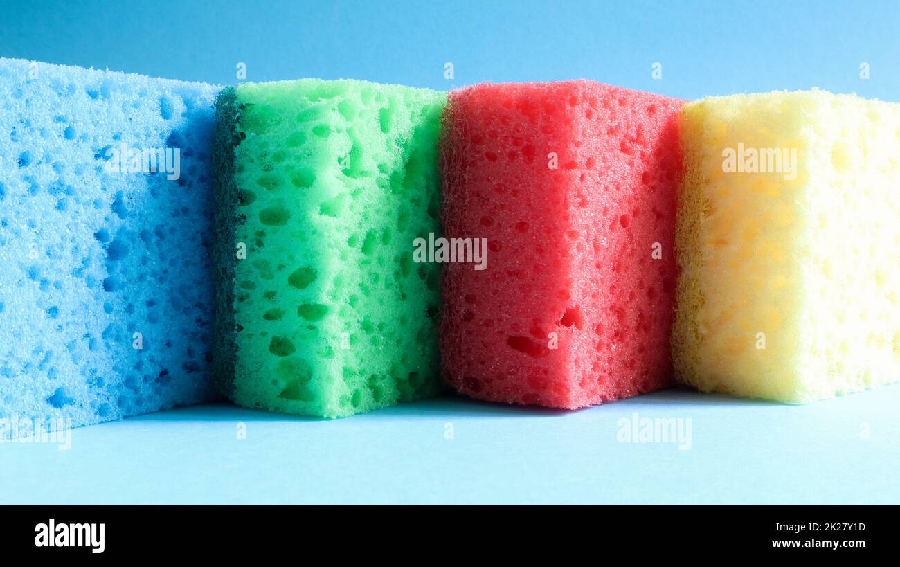 De nombreuses éponges bleues, rouges, jaunes, vertes sont utilisées pour laver et essuyer la saleté utilisée par les femmes au foyer dans la vie quotidienne. Ils sont faits de matériaux poreux tels que la mousse. bonne rétention de détergent Banque D'Images