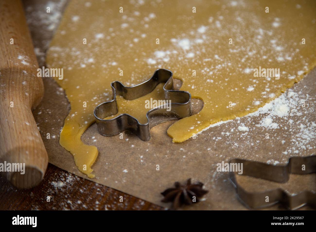 Sur le parchemin, il y a un sculpteur sous la forme d'un homme près de la pâte roulée, tout est arrosé de farine, une broche roulante et d'autres moules sont visibles, une photo dans une clef sombre Banque D'Images