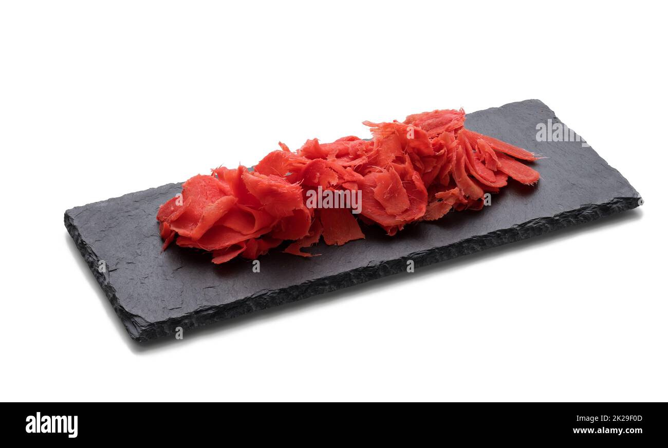 gingembre rose mariné sur un tableau en pierre noire, épice pour sushi. Arrière-plan blanc Banque D'Images