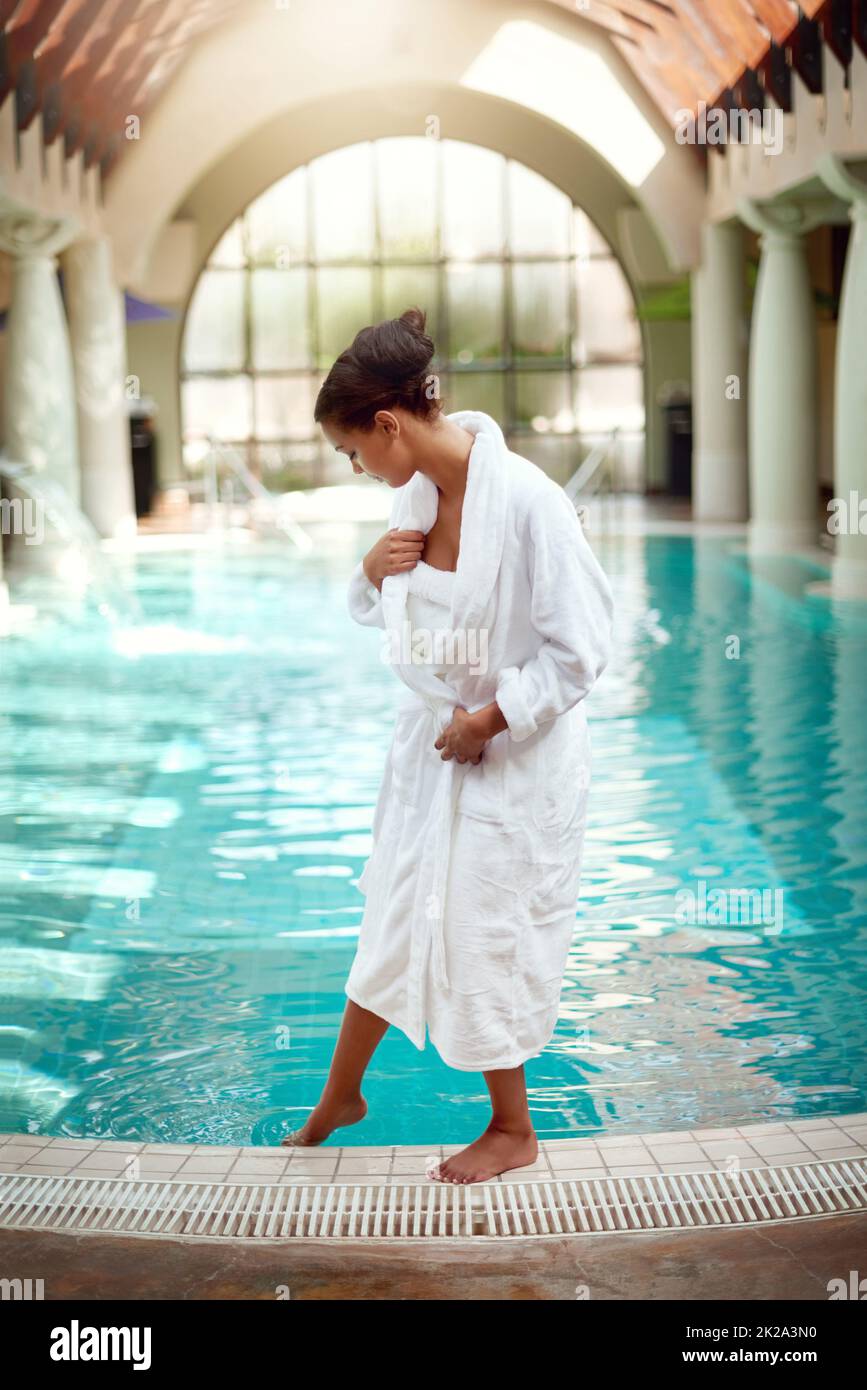 Plongez dans une journée de luxe. Photo d'une jeune femme attirante sur le point d'aller pour une baignade relaxante dans un spa. Banque D'Images