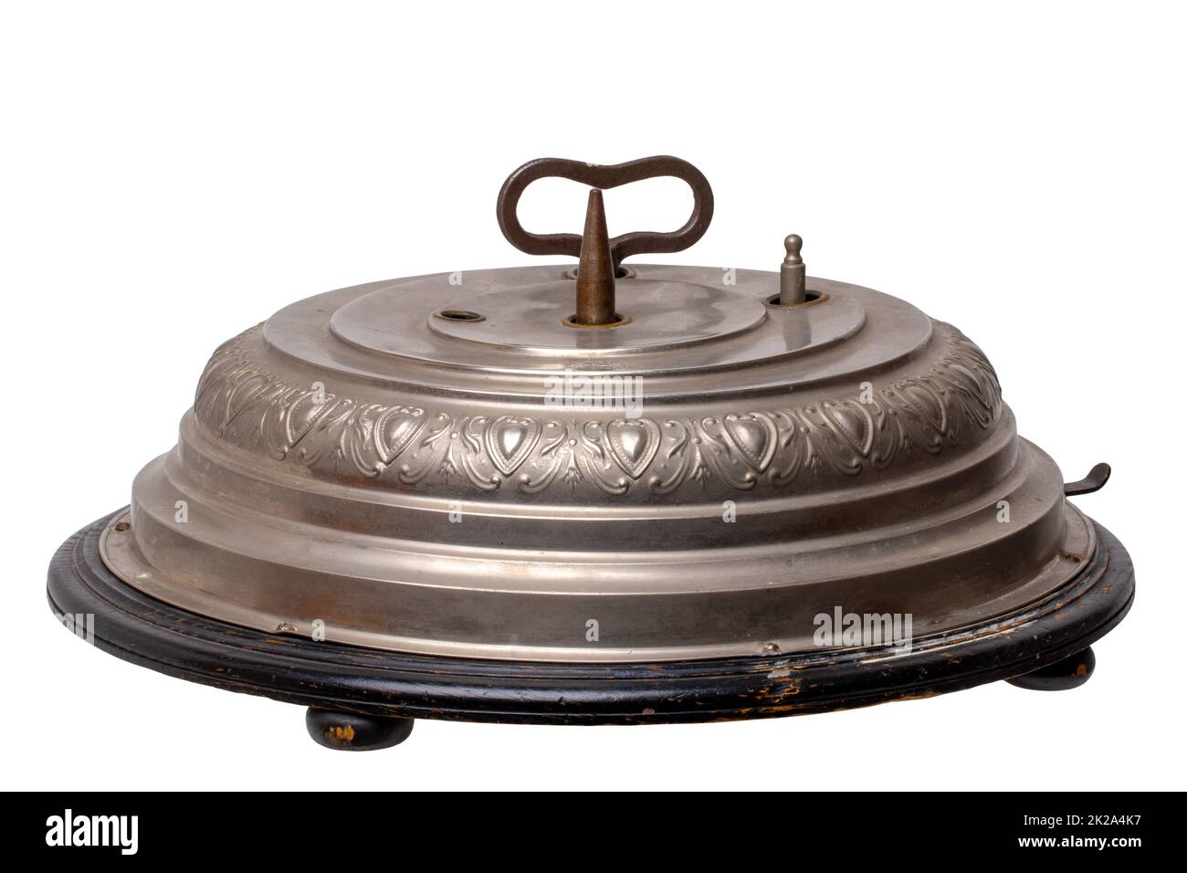 Ancien support d'arbre de Noël allemand original (1902) avec boîte à musique mécanique avec 2 chants de Noël et mécanisme de rotation pour l'arbre de Noël. Masque. Isolé sur blanc. Banque D'Images