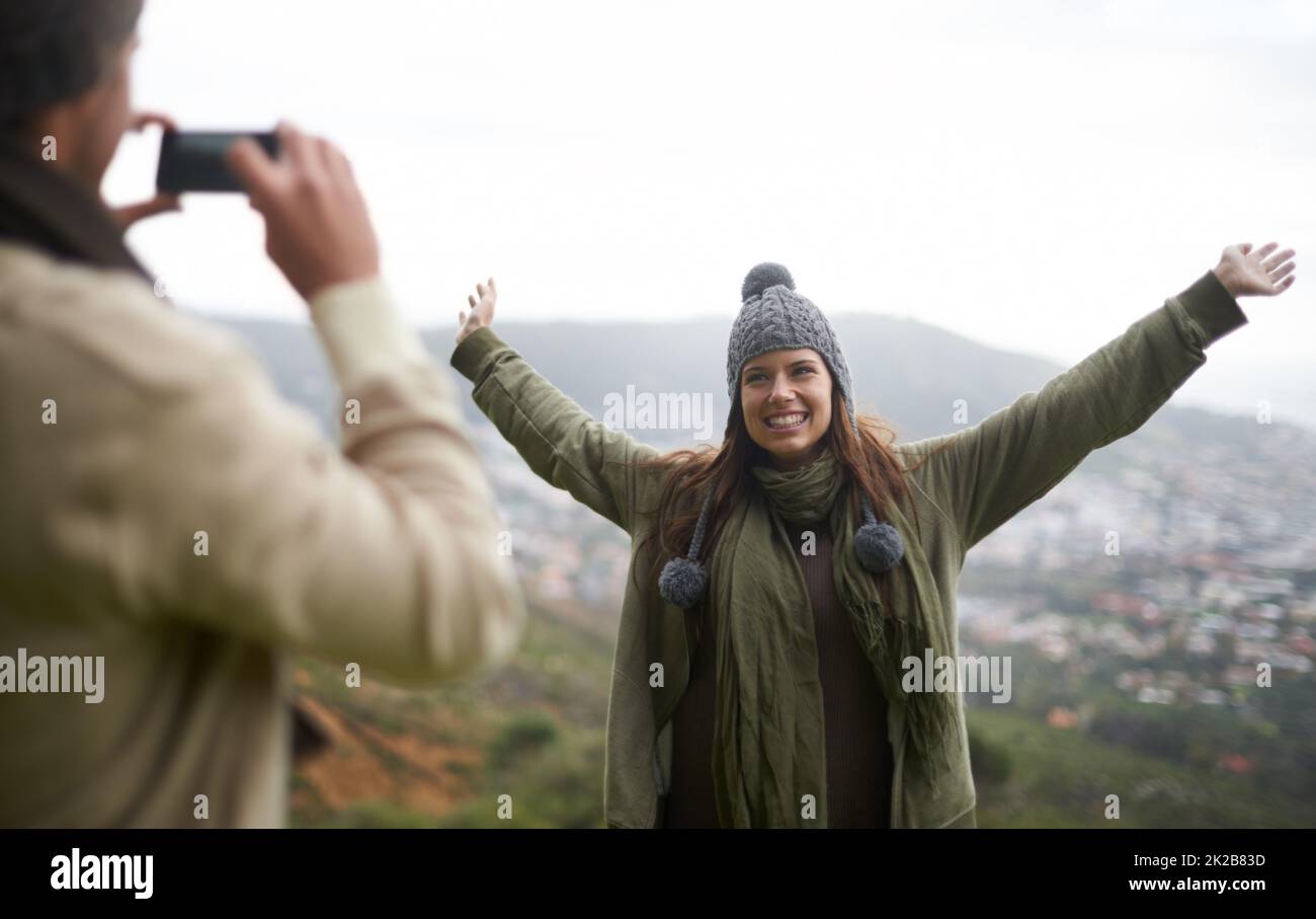 Assurez-vous d'avoir la vue. Un jeune couple prend une photo tout en randonnée dans les montagnes. Banque D'Images