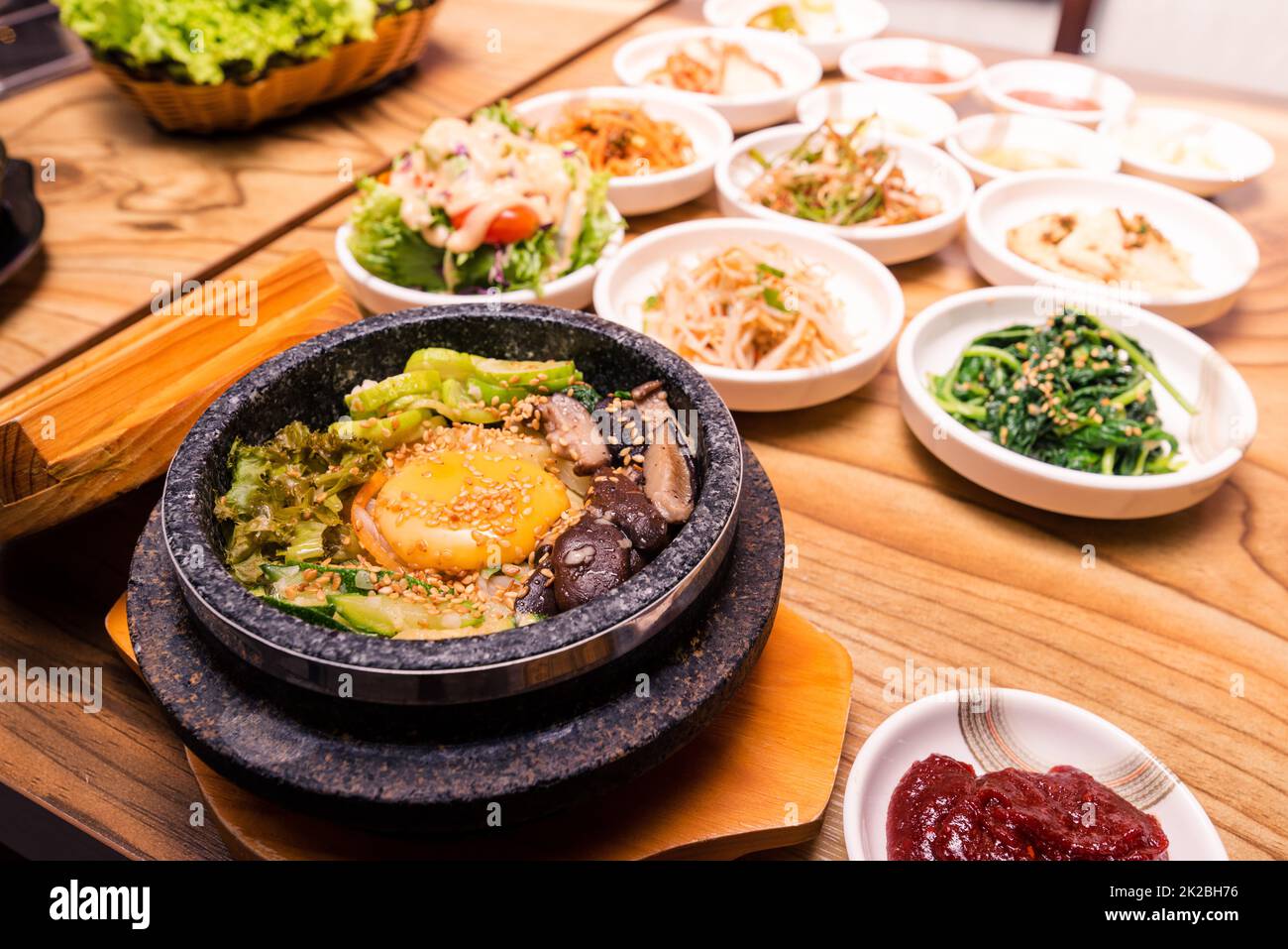 Plat traditionnel coréen - bibimbap mélange de riz avec des légumes comprend le boeuf, l'oeuf frit et le cornichon ensemble Banque D'Images