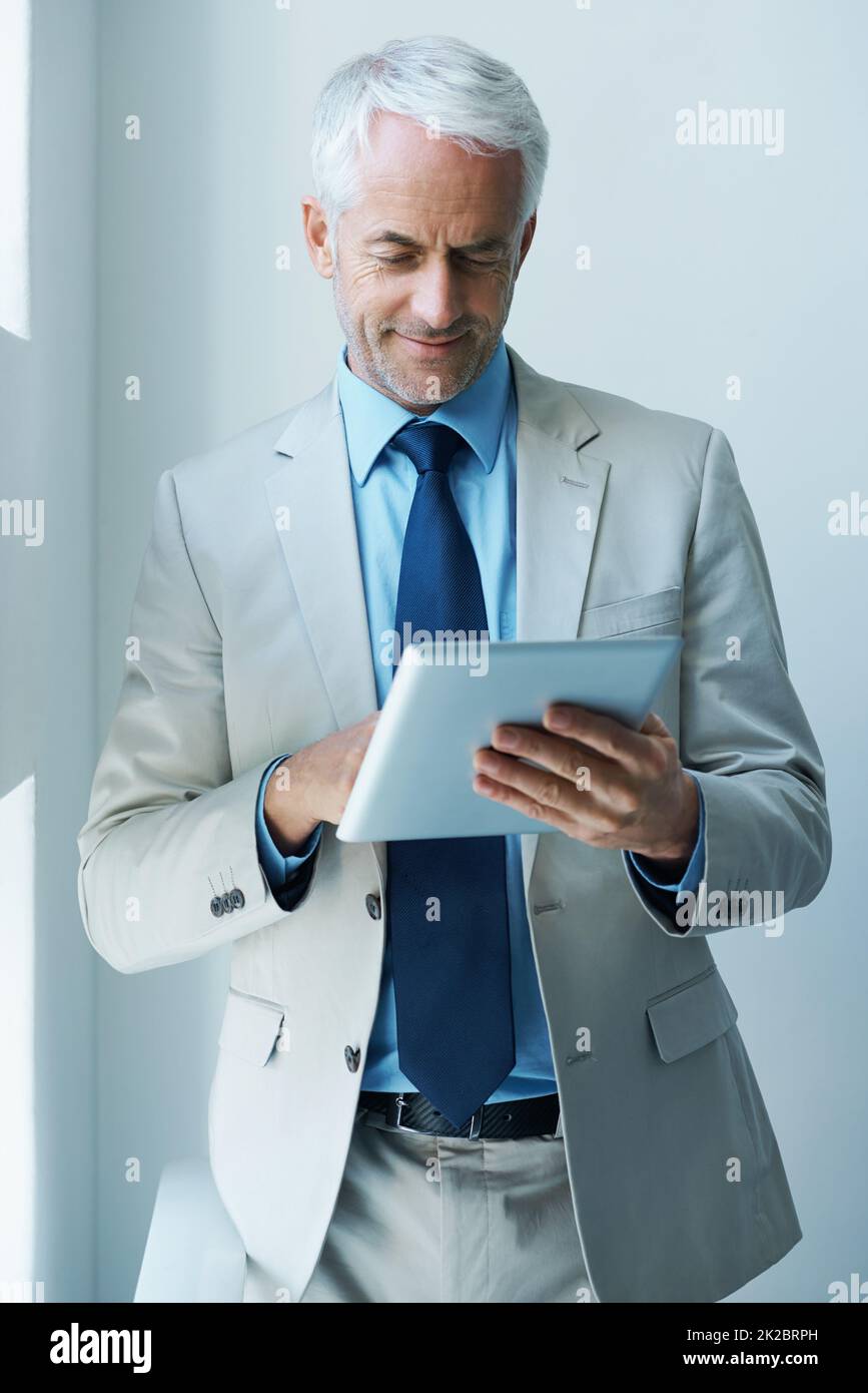 Il est temps pour les affaires. Photo d'un homme d'affaires mature utilisant une tablette numérique. Banque D'Images
