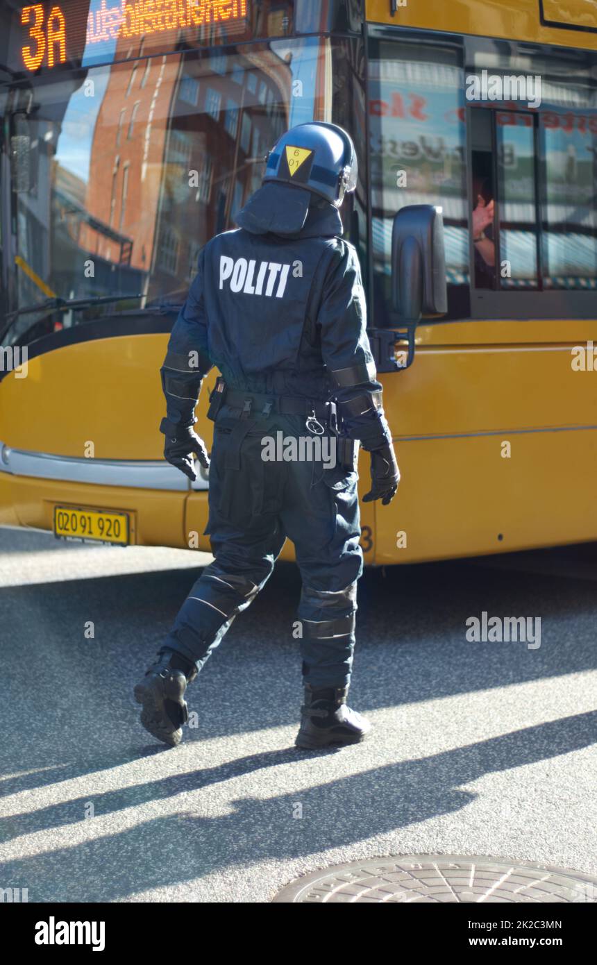 Maîtrise des foules. Vue arrière d'un policier en tenue anti-émeute. Banque D'Images
