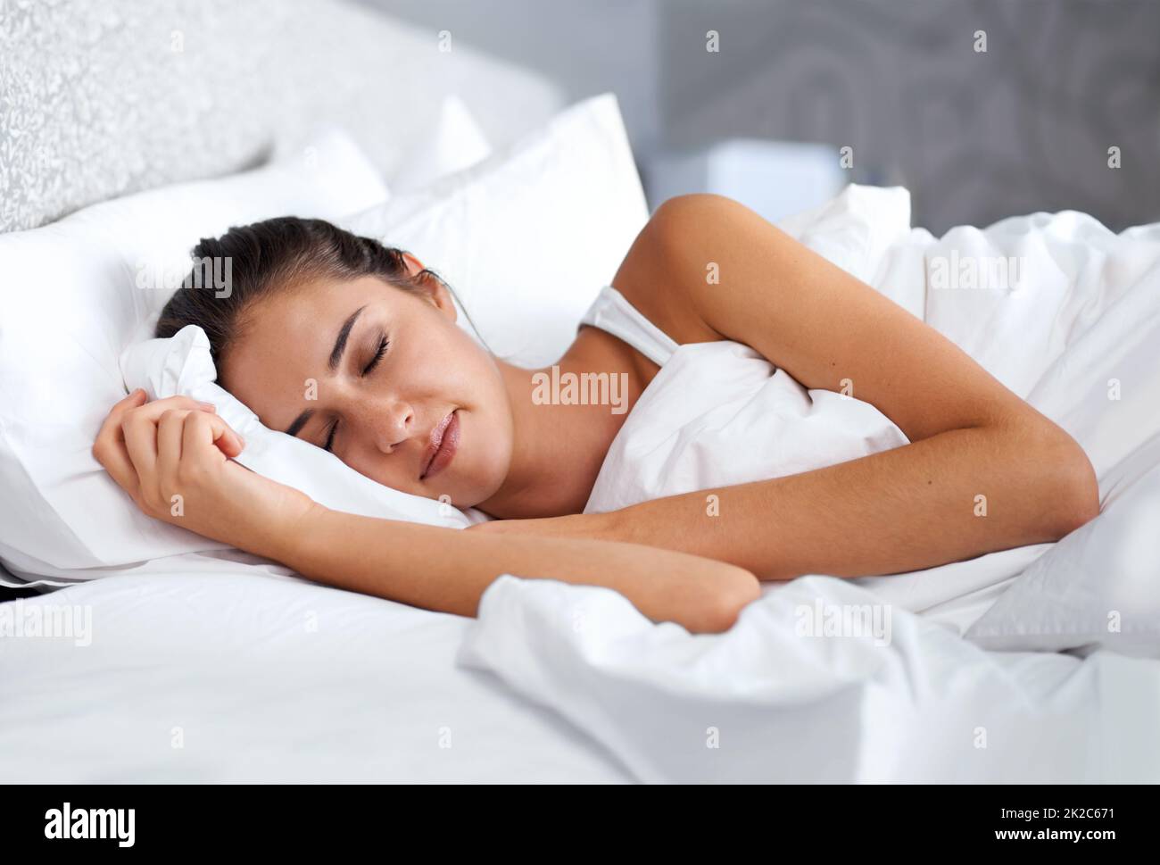 Rêver de choses heureuses. Photo courte d'une belle jeune femme au lit. Banque D'Images