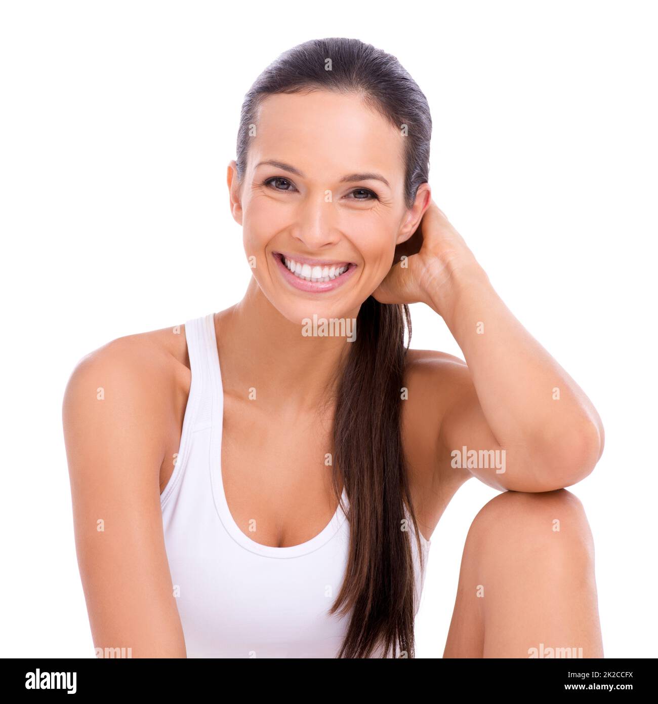 Image de la santé et de la vitalité. Studio portrait d'une femme attrayante en vêtements d'exercice isolés sur blanc. Banque D'Images