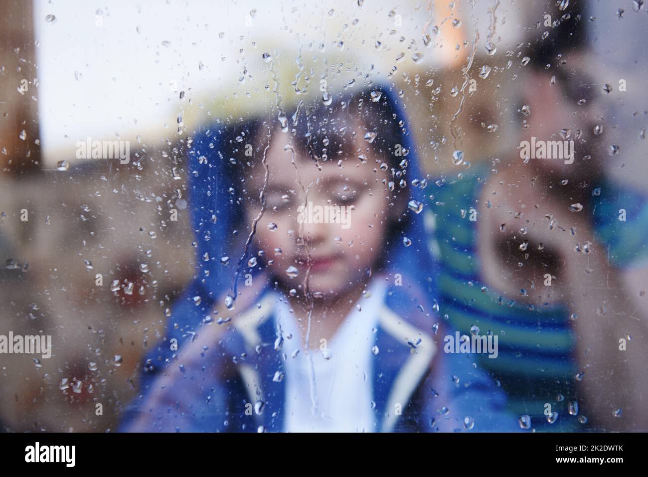 Jours de pluie sans rien à faire Un petit garçon regardant vers le bas