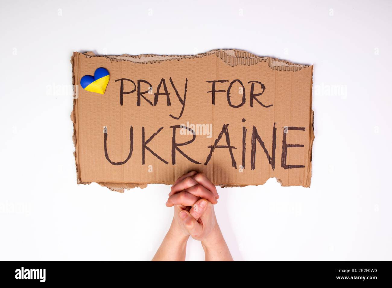 Gros plan sur la main tenant la bannière avec prier pour l'Ukraine texte Banque D'Images