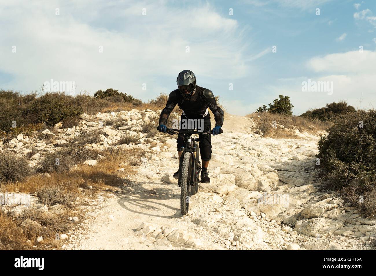 Pilote entièrement équipé d'un équipement de protection lors d'une descente sur son vélo Banque D'Images