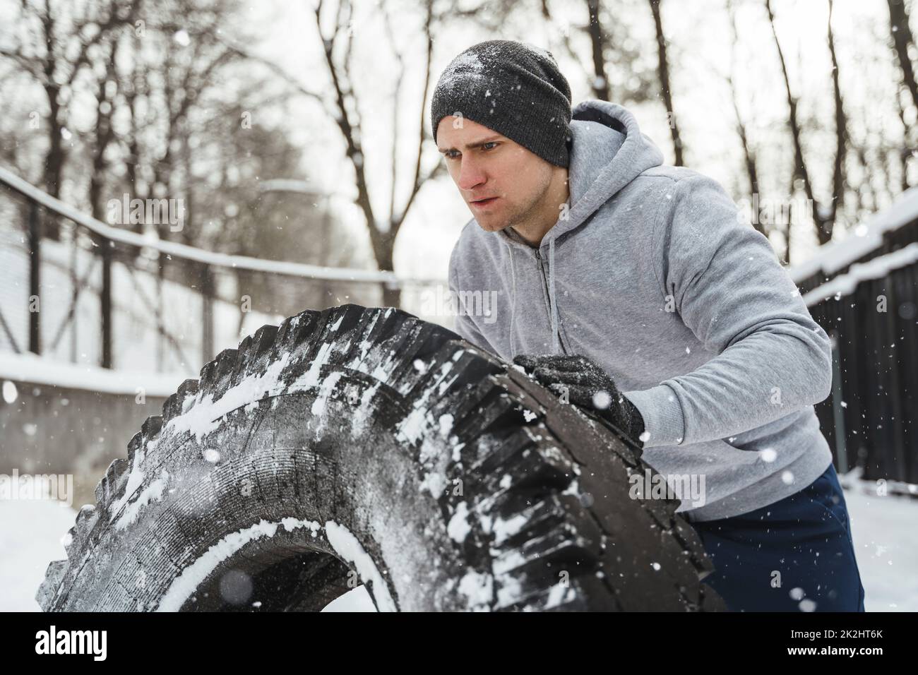 Un sportif fort pendant son entraînement multisport pendant les journées d'hiver enneigées et froides. Banque D'Images