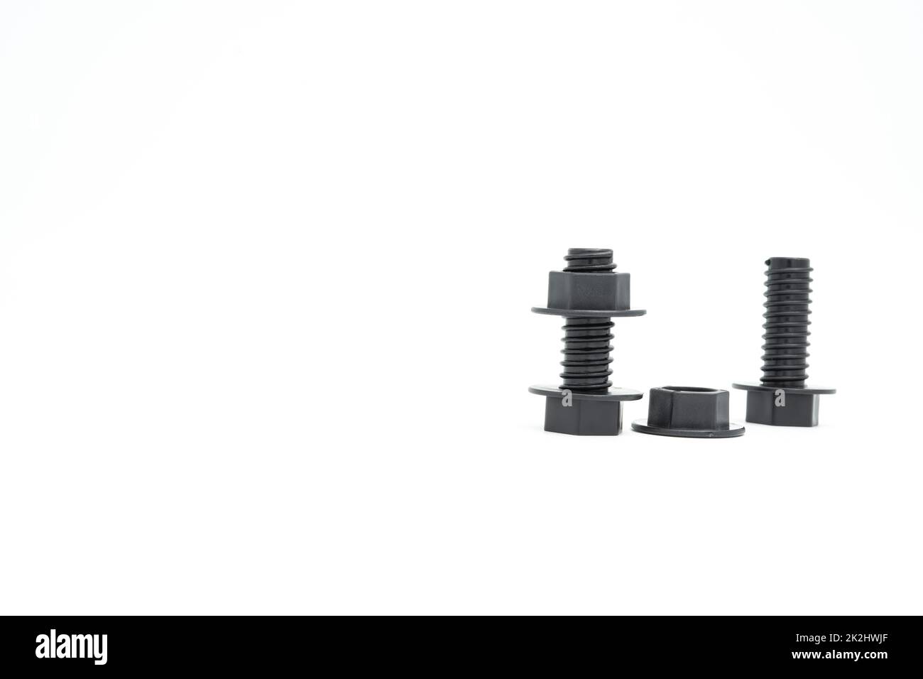 Jouet en plastique pour enfants, écrou noir sur fond blanc Banque D'Images