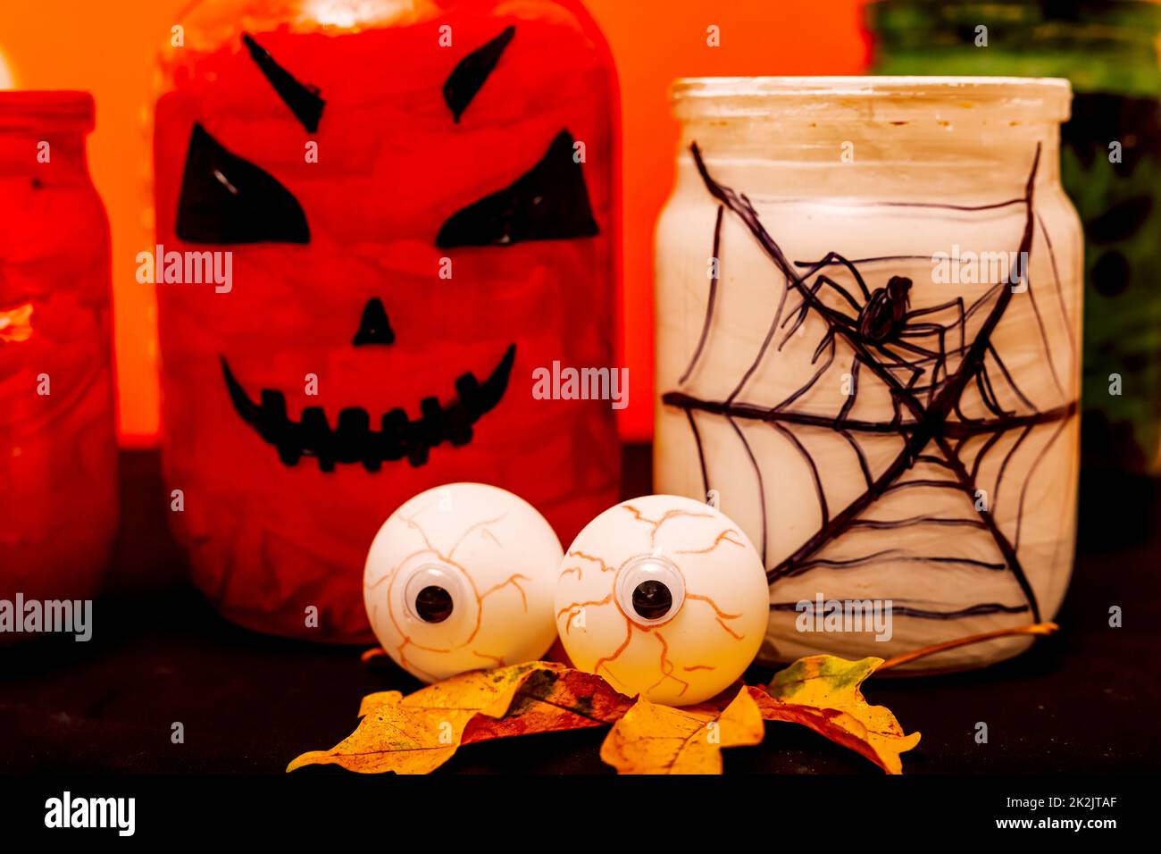 Composition d'Halloween des yeux, de la citrouille et d'un pot avec une araignée Banque D'Images