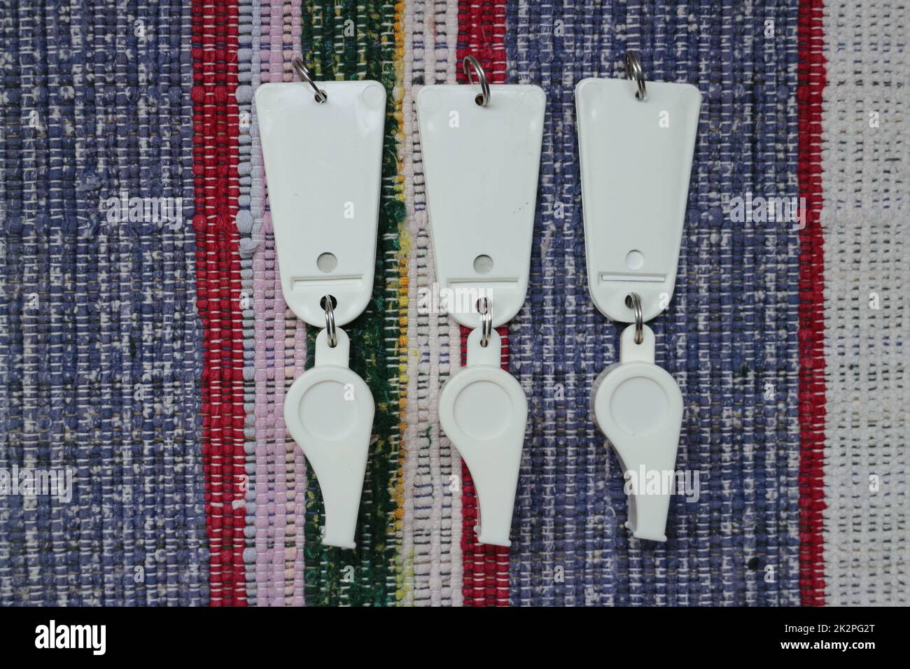 trois sifflets blancs avec une étiquette comme récompense Banque D'Images