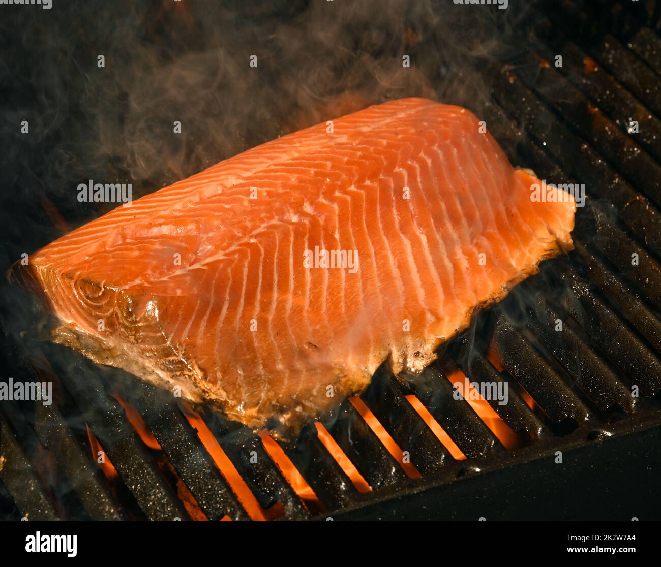 Gros plan sur le filet de saumon grillé en plein air avec grille en fonte métallique, vue en grand angle Banque D'Images