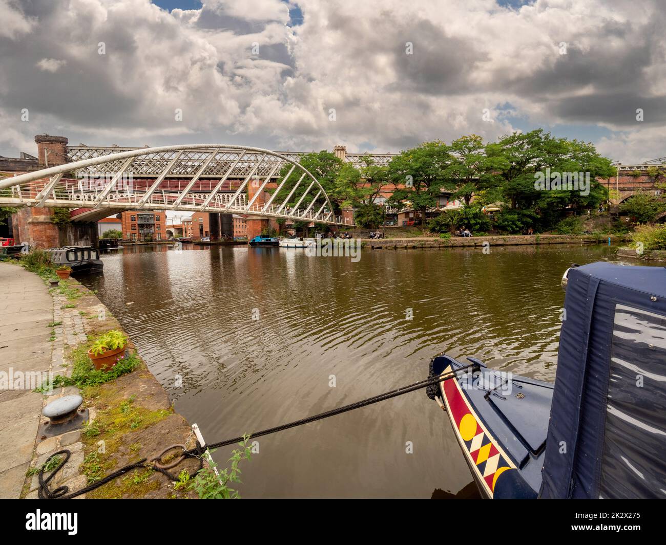 Arc d'un bateau à rames amarré avec le pont de Merchant au loin, tiré de la piste de remorquage du canal Bridgewater. Manchester. ROYAUME-UNI. Banque D'Images