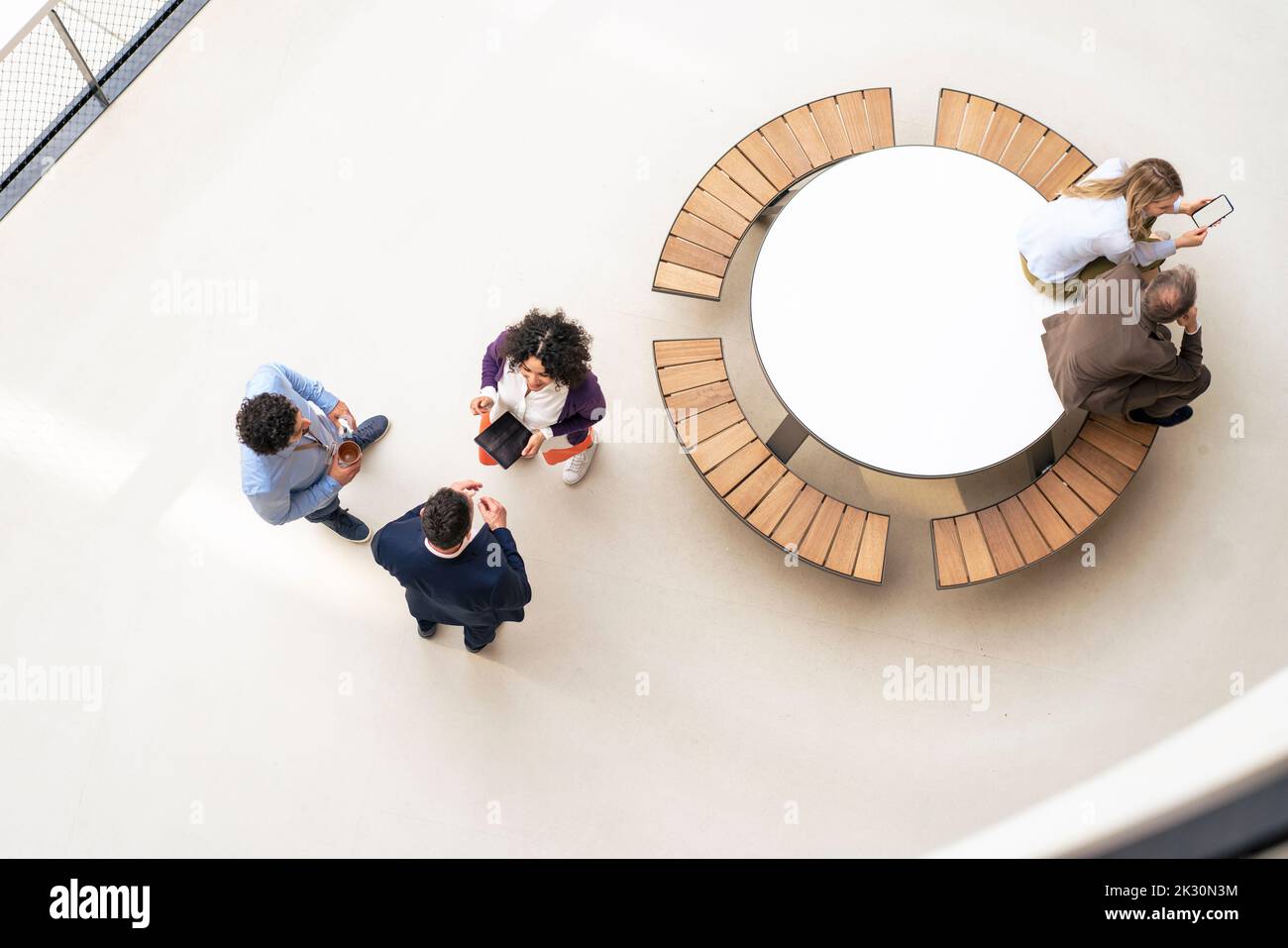 Les gens d'affaires multiraciaux discutent de stratégie dans le couloir Banque D'Images