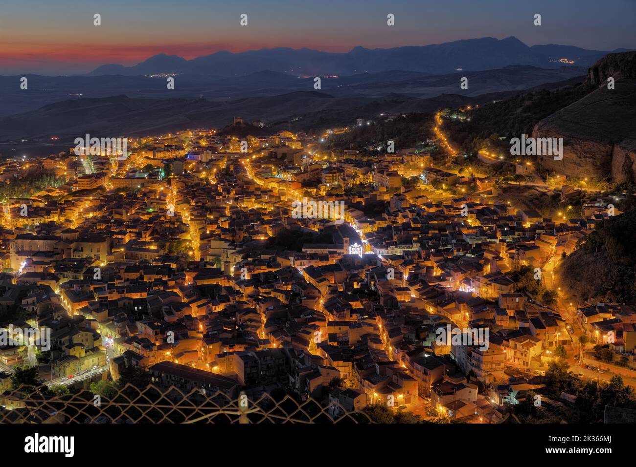 Vue aérienne nocturne des rues éclairées de Corleone au crépuscule, Sicile occidentale, Italie Banque D'Images