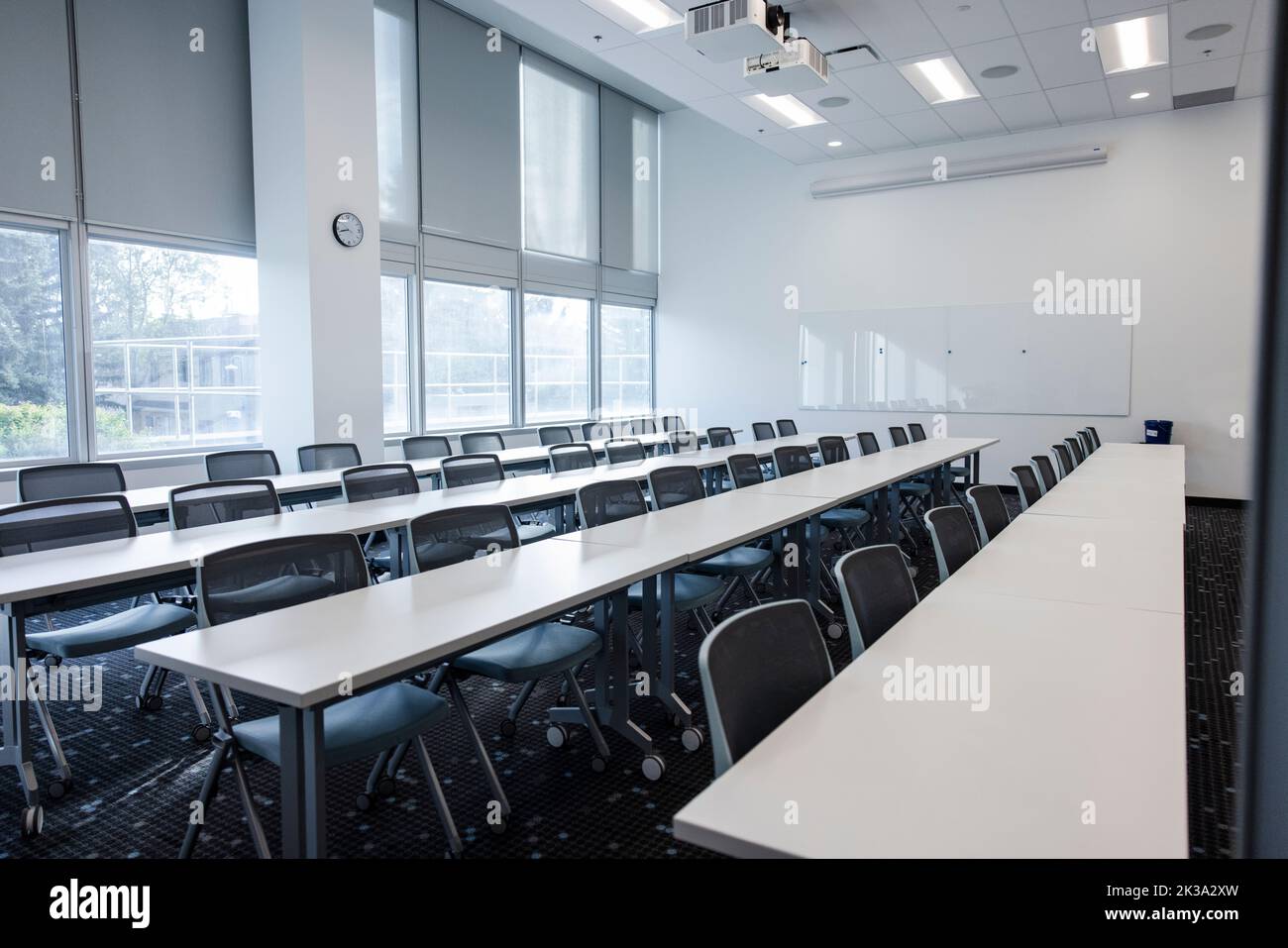Tables et chaises dans une rangée dans la salle de classe d'université Banque D'Images