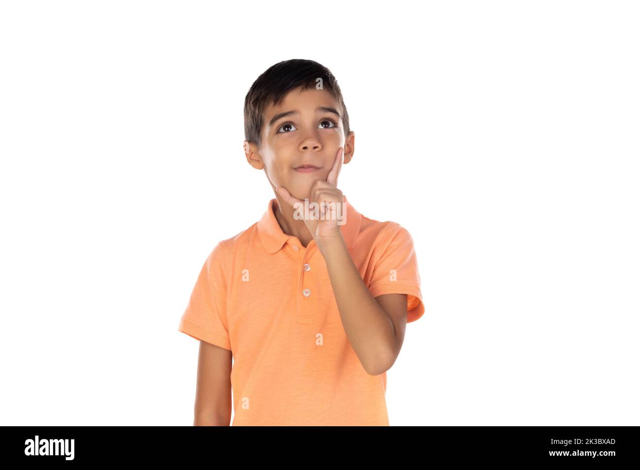 Petit enfant pensif avec t-shirt orange isolé sur fond blanc Banque D'Images