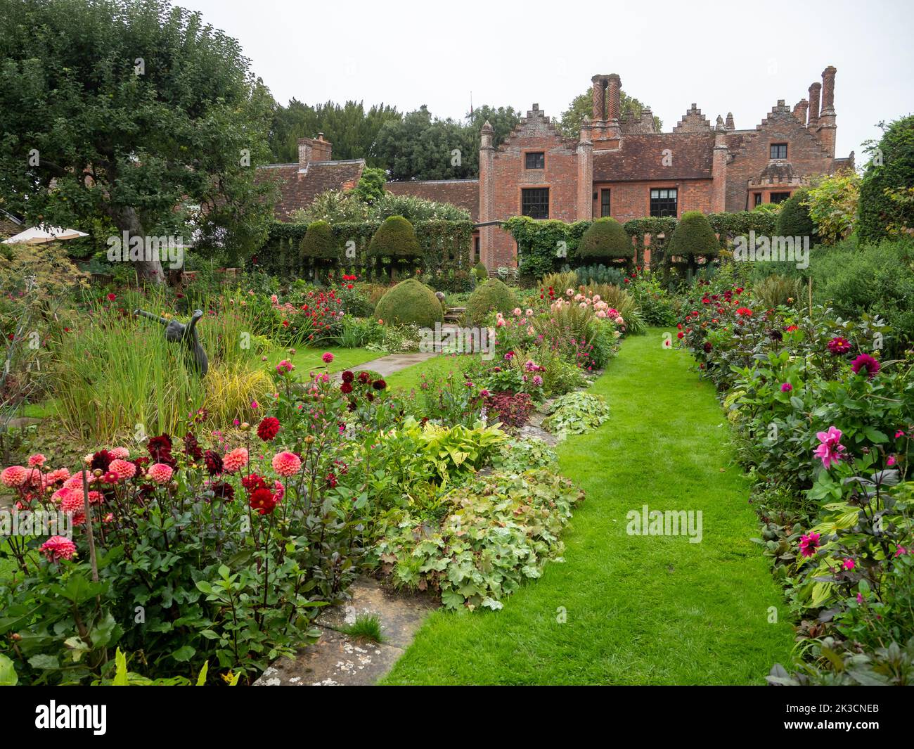 Chenies Manor House donnant sur le jardin en contrebas restauré à l'heure des dahlia lors d'un après-midi humide en septembre. Banque D'Images