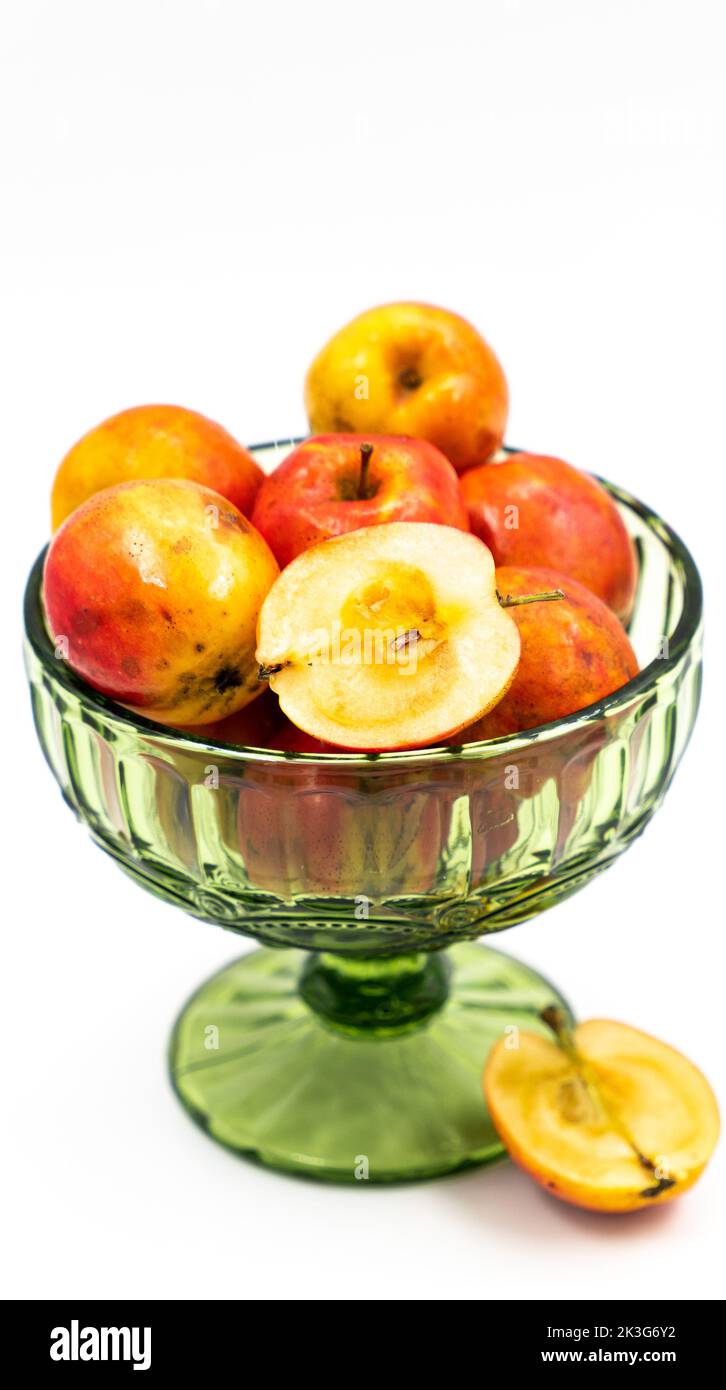 Pommes rouges fraîches dans un vase en verre sur fond blanc isolé Banque D'Images