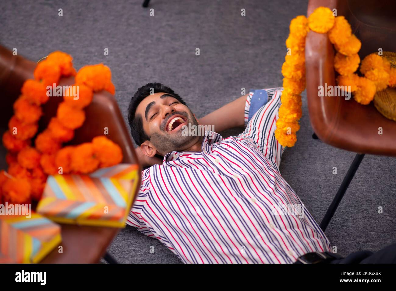 Vue en angle supérieur d'un employé allongé sur un étage de bureau pendant la fête de Diwali Banque D'Images