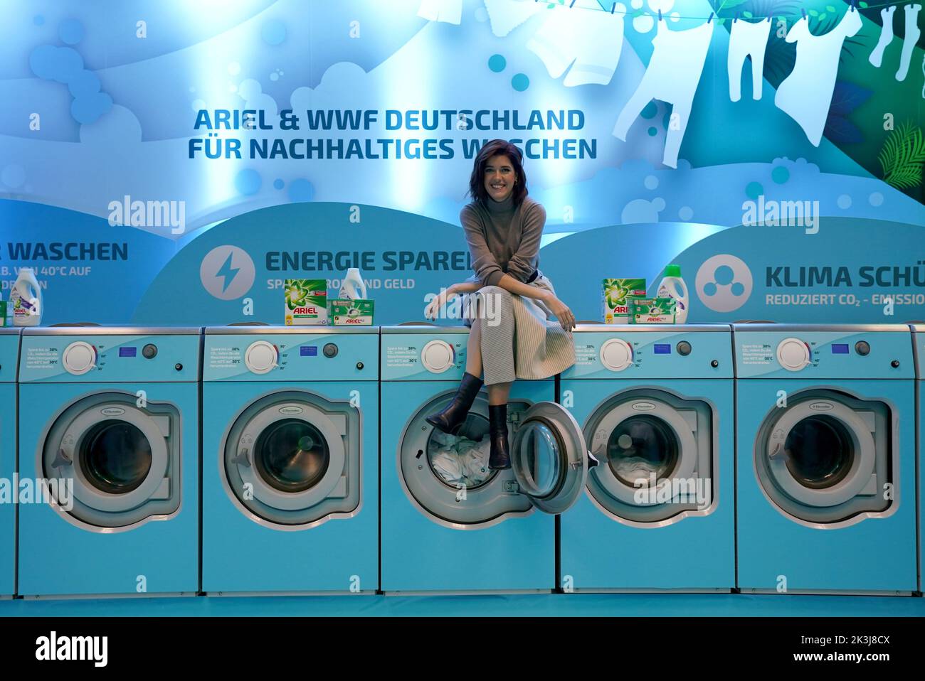 Hambourg, Allemagne. 27th septembre 2022. Marie Nasemann, influenceur du développement durable, est assise sur les machines à laver pendant la campagne de laverie automatique à froid dans le quartier de Winterhude. Du vendredi au dimanche, les citoyens peuvent laver gratuitement leur linge à un maximum de 30 degrés. Les initiateurs de l'action sont la fondation environnementale WWF et le fabricant de détergents Ariel (groupe de biens de consommation Procter & Gamble). (À dpa 'la campagne de laverie automatique froide à Hambourg vise à encourager les gens à repenser') Credit: Marcus Brandt/dpa/Alamy Live News Banque D'Images