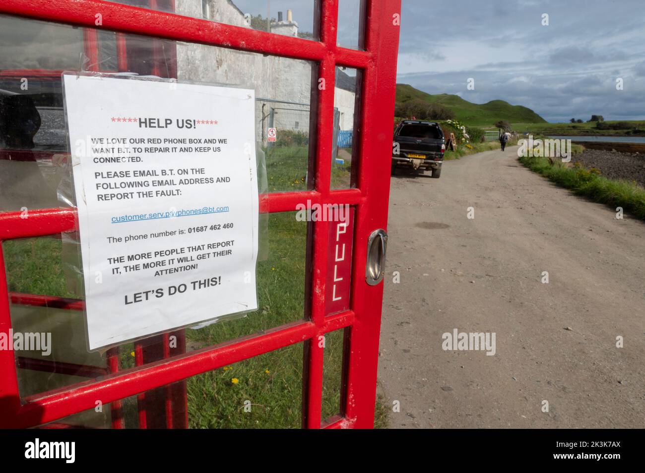 Septembre 2022: Île de Canna, Hébrides intérieures, Écosse l'ancienne boîte téléphonique rouge sur la route le long de la rive Banque D'Images