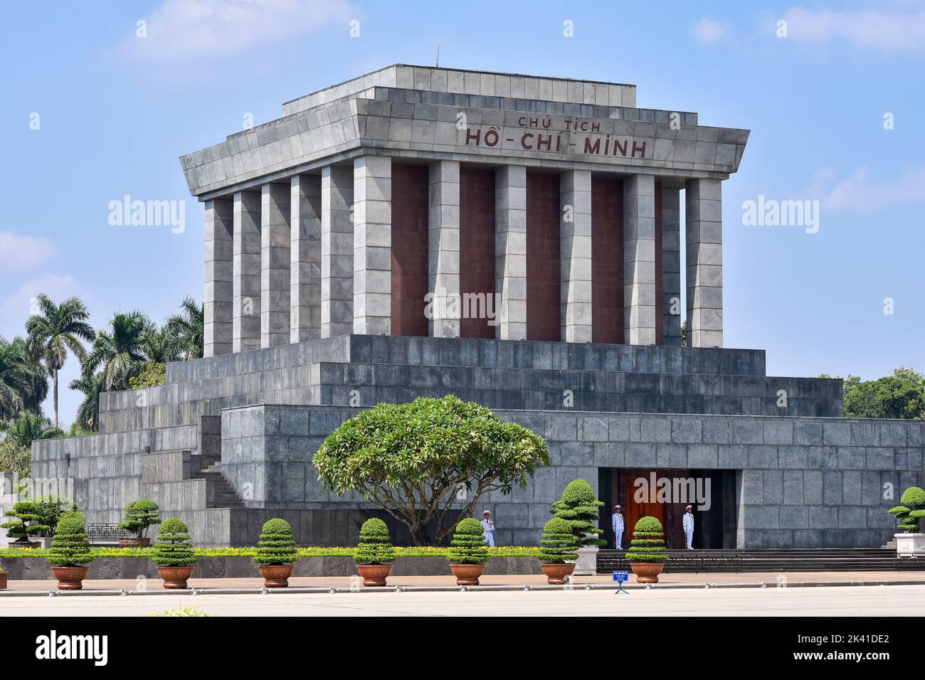 Le majestueux mausolée du président Ho Chi Minh a été surveillé par trois gardes en uniforme blanc par une journée ensoleillée. Banque D'Images