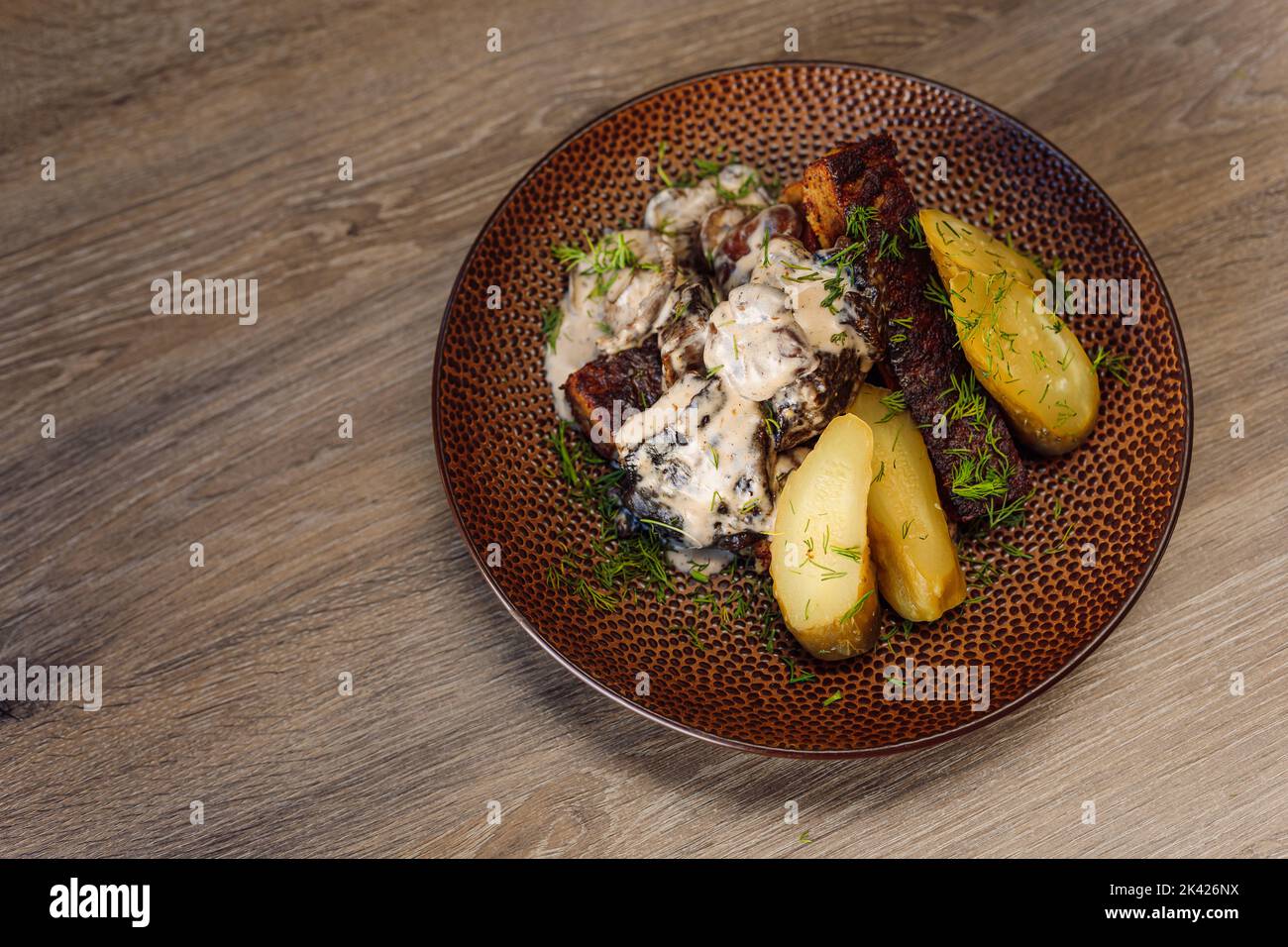 Rôti de viande de bœuf avec pomme de terre, poivre dans une sauce aigre blanche avec verdure sur l'assiette du café ou de la table de restaurant. Haut Banque D'Images Rôti de viande de bœuf avec pomme de terre, poivre dans une sauce aigre blanche avec verdure sur l'assiette du café ou de la table de restaurant. Haut Banque D'Images