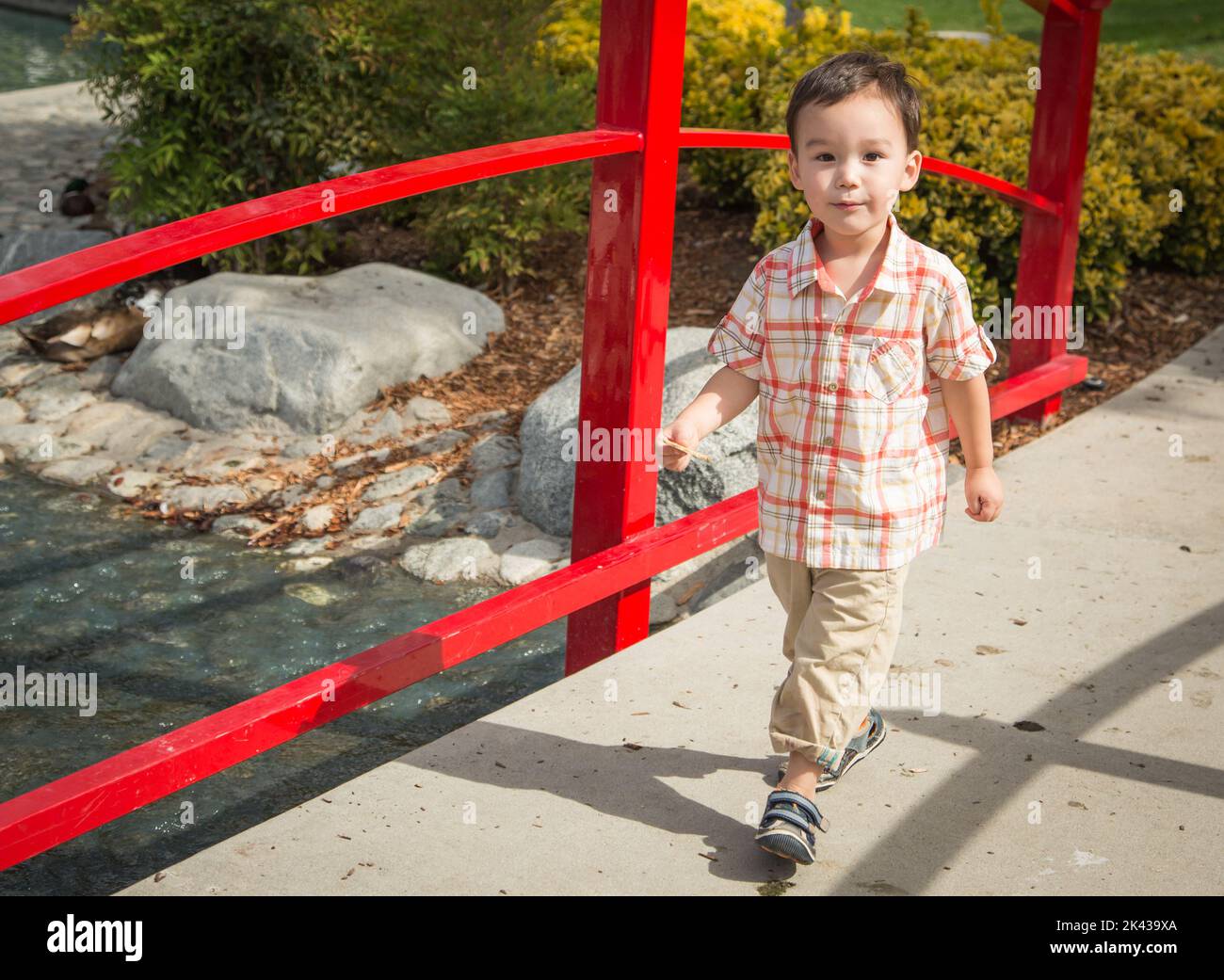 Un jeune garçon chinois et caucasien s'amuser au parc. Banque D'Images
