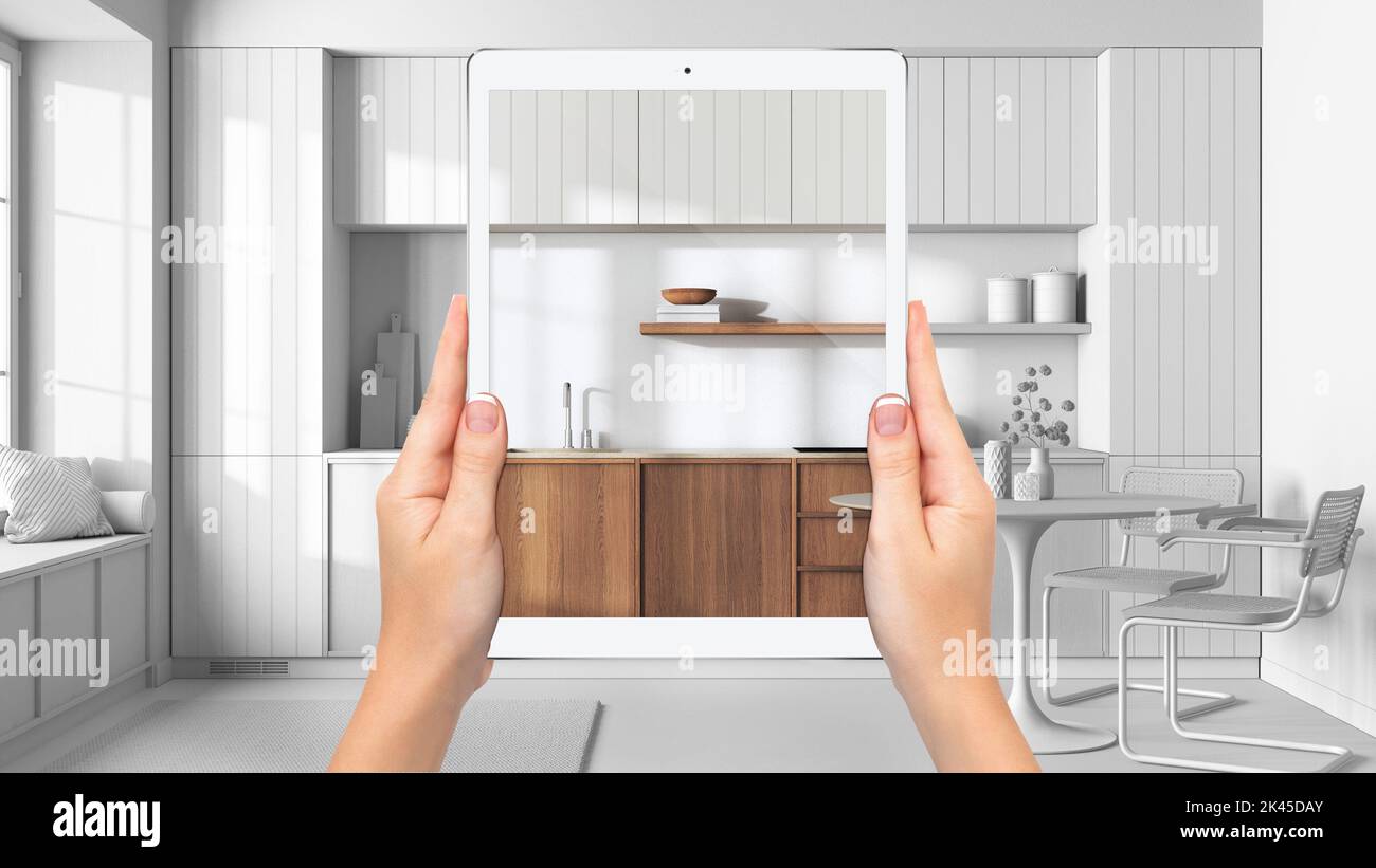 Main tenant tablette montrant la cuisine japandi, fond de projet blanc total, concept de réalité augmentée, application pour simuler le mobilier et interio Banque D'Images