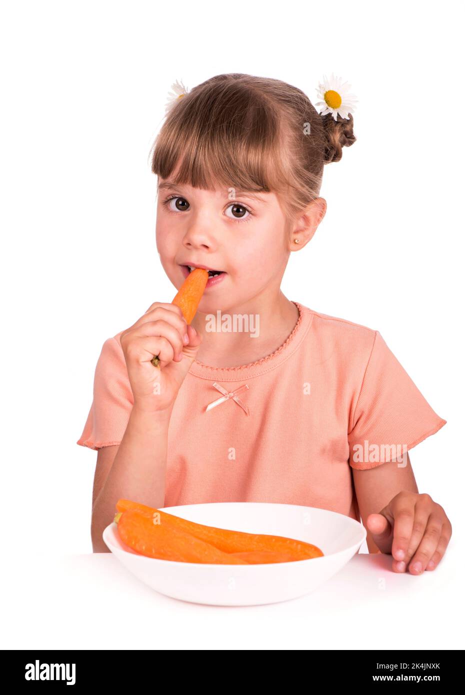 Jolie petite fille avec la carotte sur fond blanc Banque D'Images