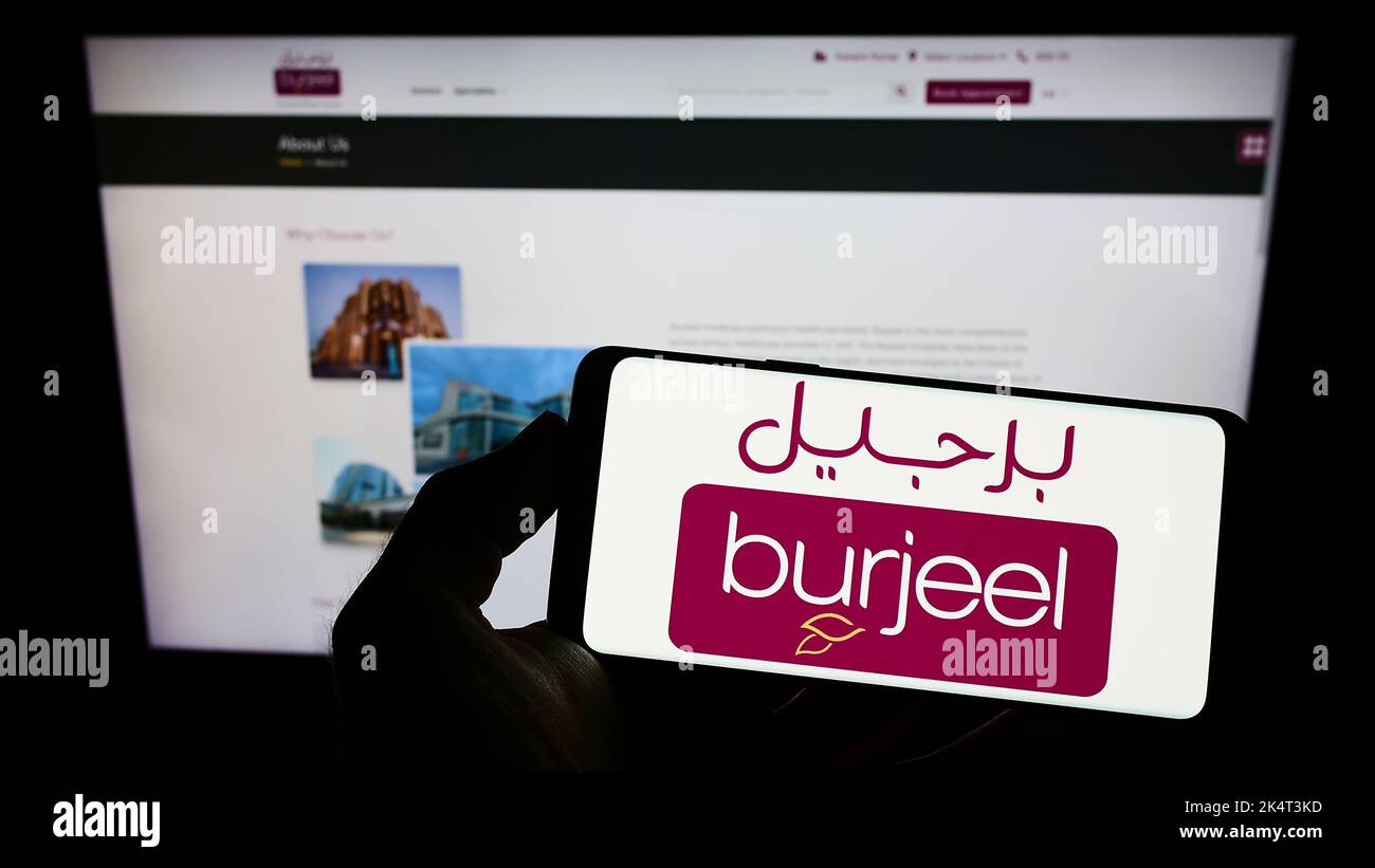 Personne tenant un smartphone avec le logo de l'opérateur de l'hôpital Emirati Burjeel à l'écran devant le site Web de l'entreprise. Mise au point sur l'affichage du téléphone. Banque D'Images