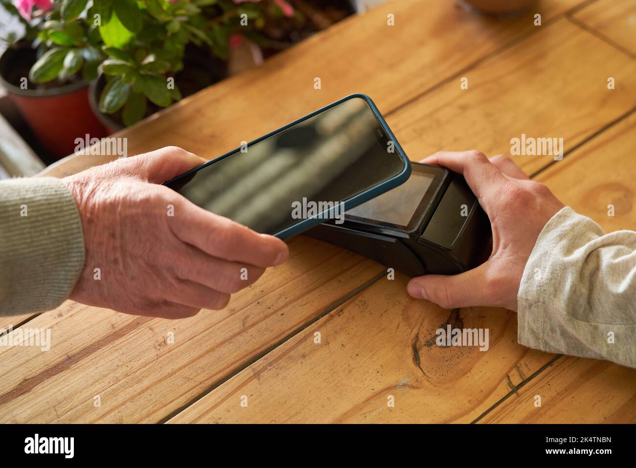 Paiement mobile avec smartphone vers lecteur NFC lors du paiement d'un fleuriste Banque D'Images