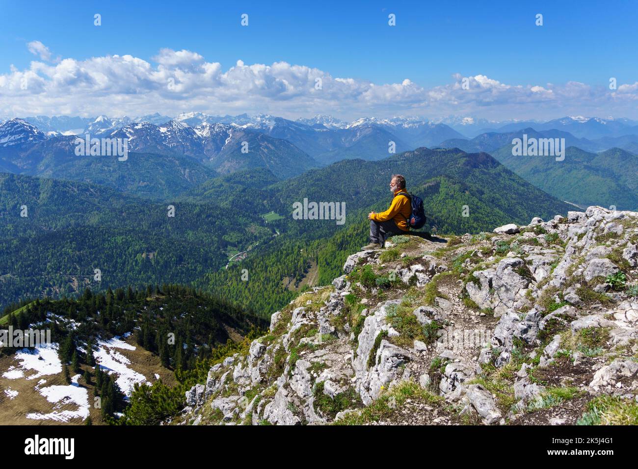 Randonneur, senior, 63 ans, au sommet de Rossstein, jouissant d'une vue sur les monts Karwendel, Kreuth, Mangfall, haute-Bavière, Allemagne Banque D'Images